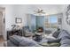 Cozy living room with a fireplace, ceiling fan, and large window for natural light at 17297 Wilde Ave # 205, Parker, CO 80134