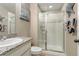 Bright bathroom with granite countertop vanity and glass enclosed tiled shower at 7251 S Old Hammer Way, Aurora, CO 80016