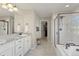 Bathroom with a double vanity, walk-in shower, and a separate soaking tub at 7251 S Old Hammer Way, Aurora, CO 80016