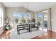 Bright dining area featuring large windows, a modern light fixture, and sliding glass doors to the backyard at 7251 S Old Hammer Way, Aurora, CO 80016