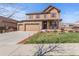 Charming two-story home with a three-car garage and inviting front porch at 7251 S Old Hammer Way, Aurora, CO 80016