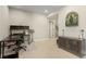Bright home office with neutral walls and carpet, a large desk, and custom cabinet for storage at 7251 S Old Hammer Way, Aurora, CO 80016
