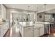 Gourmet kitchen with a large island, farm sink, and modern finishes at 7251 S Old Hammer Way, Aurora, CO 80016