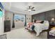 Spacious main bedroom featuring a ceiling fan, a large window, and a statement headboard at 7251 S Old Hammer Way, Aurora, CO 80016
