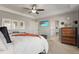 Bright main bedroom with an ensuite bathroom, tray ceiling, and a ceiling fan at 7251 S Old Hammer Way, Aurora, CO 80016
