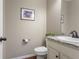 Modern powder room with neutral tones, elegant fixtures, and a decorative framed print at 7251 S Old Hammer Way, Aurora, CO 80016