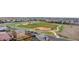 Aerial view showcasing a neighborhood with a park and baseball field at 15484 E 115Th Ave, Commerce City, CO 80022