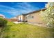 Spacious backyard with green lawn, patio set, and attractive flowering tree providing shade at 15484 E 115Th Ave, Commerce City, CO 80022