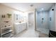 Bright bathroom featuring a modern vanity, decorative shelving, and frameless glass shower at 15484 E 115Th Ave, Commerce City, CO 80022