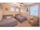 Charming bedroom featuring two twin beds, neutral decor, and a ceiling fan, illuminated by natural light at 15484 E 115Th Ave, Commerce City, CO 80022
