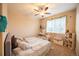 Bright bedroom with ample sunlight, a ceiling fan, and neutral color scheme at 15484 E 115Th Ave, Commerce City, CO 80022