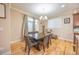 Cozy dining room featuring hardwood floors, a modern chandelier, and a neutral color palette at 15484 E 115Th Ave, Commerce City, CO 80022