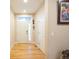 Bright entryway with wood floors, a white door, and natural light at 15484 E 115Th Ave, Commerce City, CO 80022
