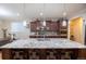 Kitchen island featuring seating for four with stainless steel appliances and pendant lighting at 15484 E 115Th Ave, Commerce City, CO 80022