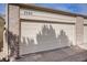 Attached garage door with house number and brick accents under bright sunlight at 7580 S Cove Cir, Centennial, CO 80122