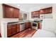 Functional kitchen featuring stainless steel appliances, sleek countertops, and wood cabinets at 7580 S Cove Cir, Centennial, CO 80122