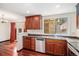 Functional kitchen featuring stainless steel appliances, sleek countertops, and wood cabinets at 7580 S Cove Cir, Centennial, CO 80122