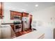 Functional kitchen featuring stainless steel appliances, sleek countertops, and wood cabinets at 7580 S Cove Cir, Centennial, CO 80122