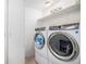 Well-organized laundry room with modern washer and dryer set, plus storage shelving at 7580 S Cove Cir, Centennial, CO 80122