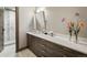 Well-lit bathroom showcasing a long vanity with modern sinks and a view of a glass enclosed shower at 310 N Fuller Placer Rd, Breckenridge, CO 80424