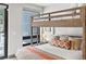 Comfortable bunk room with unique accents and lots of natural light coming in from the window and door at 310 N Fuller Placer Rd, Breckenridge, CO 80424