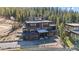 Contemporary multi-story home featuring expansive windows and outdoor balconies, blending with a lush wooded environment at 310 N Fuller Placer Rd, Breckenridge, CO 80424
