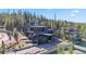 Modern home with a layered facade, multiple balconies, and tall windows amid a dense forest landscape at 310 N Fuller Placer Rd, Breckenridge, CO 80424
