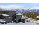 Contemporary home with steel staircase and snow-covered mountains in the background at 310 N Fuller Placer Rd, Breckenridge, CO 80424