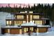 Modern, multi-story home with balconies, and mountain views surrounded by snow at 310 N Fuller Placer Rd, Breckenridge, CO 80424