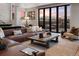 Cozy living room featuring a leather sofa, mountain views, and natural light at 310 N Fuller Placer Rd, Breckenridge, CO 80424