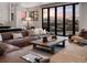 Cozy living room featuring a leather sofa, mountain views, and natural light at 310 N Fuller Placer Rd, Breckenridge, CO 80424