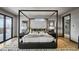 Main bedroom boasts a stylish canopy bed and scenic mountain views at 310 N Fuller Placer Rd, Breckenridge, CO 80424