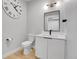 Modern bathroom featuring a stylish vanity with a black framed mirror and light oak floors at 4232 Jason St # 7, Denver, CO 80211