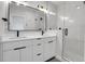 Modern bathroom with double vanity, marble wall tiles, and sleek glass shower door at 4232 Jason St # 7, Denver, CO 80211