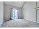 Bright bedroom with high ceilings, neutral carpet and large sliding glass doors to a balcony at 4232 Jason St # 7, Denver, CO 80211