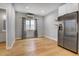 Open dining area featuring hardwood floors, natural light, stainless steel refrigerator, and neutral decor at 4232 Jason St # 7, Denver, CO 80211