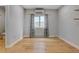 Bright dining area showcasing hardwood floors, neutral decor, and a view to a half bathroom at 4232 Jason St # 7, Denver, CO 80211