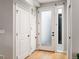 Bright entryway showcases hardwood floors and a modern white door with frosted glass and sidelight window at 4232 Jason St # 7, Denver, CO 80211