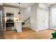 Open kitchen with stainless steel appliances and a breakfast bar transitions to the upper floors at 4232 Jason St # 7, Denver, CO 80211