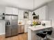 Modern kitchen features sleek white cabinetry, stainless steel appliances and a breakfast bar at 4232 Jason St # 7, Denver, CO 80211