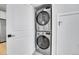 Efficient laundry area features a stacked washer and dryer set for space-saving convenience at 4232 Jason St # 7, Denver, CO 80211