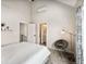 Bright main bedroom with high ceilings, modern decor, a cozy chair, and ensuite bathroom access at 4232 Jason St # 7, Denver, CO 80211