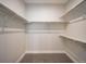 Spacious walk-in closet with ample shelving and gray carpet flooring, ready for organized storage at 4232 Jason St # 7, Denver, CO 80211