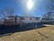 The backyard has a deck with stairs down to a grassy area and fenced-in perimeter at 1419 S Terry St, Longmont, CO 80501