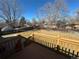 A spacious backyard with a wood fence, a deck, and some trees on a sunny day at 1419 S Terry St, Longmont, CO 80501