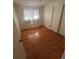 A clean bedroom provides a functional space with hardwood floors and ample natural light at 1419 S Terry St, Longmont, CO 80501