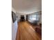 This living room has hardwood floors, a large window and an adjacent sitting area or sunroom at 1419 S Terry St, Longmont, CO 80501