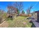 Backyard featuring a shed, mature trees, and partial fencing at 2826 S Lamar St, Denver, CO 80227