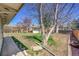 Backyard featuring bare trees, a storage shed, and a partially fenced yard at 2826 S Lamar St, Denver, CO 80227