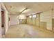 A plain, unfinished basement with concrete walls and floors, lit by fluorescent lights at 2826 S Lamar St, Denver, CO 80227